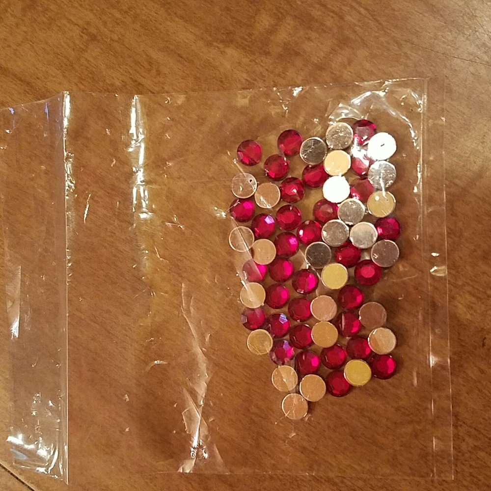 Round, red, acrylic stones for craft projects.